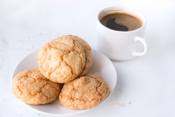 Cup of black coffee, some shortbread on a plate
