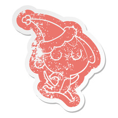 cute cartoon distressed sticker of a dog wearing santa hat