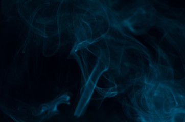 Blue smoke on black background