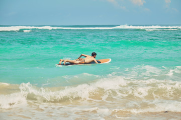 Fototapeta na wymiar Surfer man with surfboard enjoying on the beach. Summer concept.