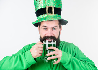 Irish pub. Alcohol consumption integral part saint patricks day. Irish culture. Man bearded hipster funny hat drink pint beer. Cheers concept. Colored green beer. Green beer part of celebration
