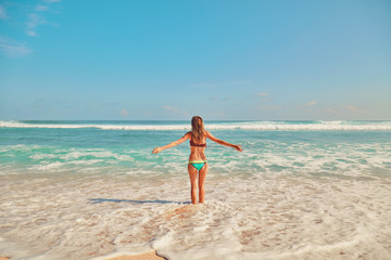 Beautiful woman enjoying on the tropical beach. Summer concept.