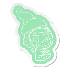 cartoon  sticker of a crying astronaut wearing santa hat