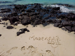 Maurice text on sand on beach