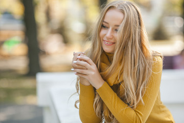 Portrait of very attractive young woman outdoor. Beautiful blond lady at urban background. Stylish female closeup portrait.