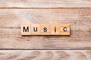 MUSIC word written on wood block. MUSIC text on wooden table for your desing, concept