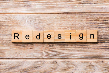 REDESIGN word written on wood block. REDESIGN text on wooden table for your desing, concept