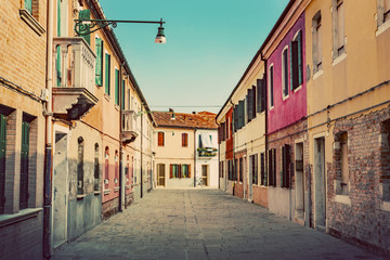 Street in Burano, Italy on sunny day.