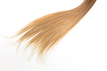Piece of blonde hair on white isolated background