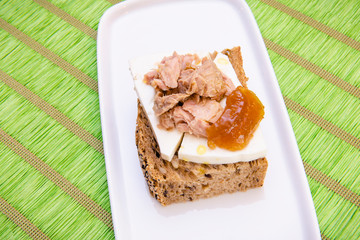 Cereal bread with fresh cheese tuna and marmalade