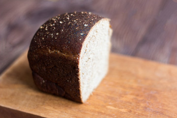 rye grey bread with spices on wooden background