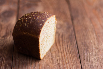 rye grey bread with spices on wooden background