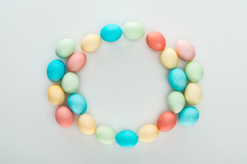 top view of colorful easter eggs as frame isolated on grey