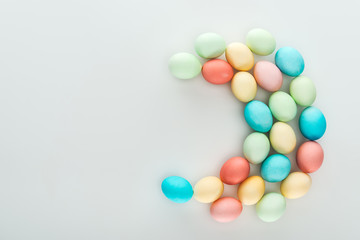 top view of pastel colorful easter eggs isolated on grey
