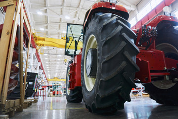 A number of modern tractors for agriculture are being finalized by workers at the final stage of production at a huge plant.