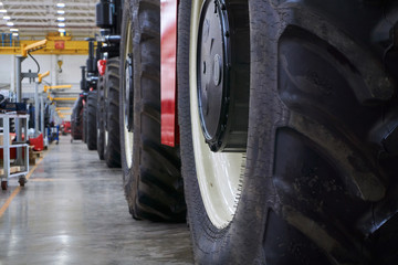 A number of modern tractors for agriculture are being finalized by workers at the final stage of production at a huge plant.