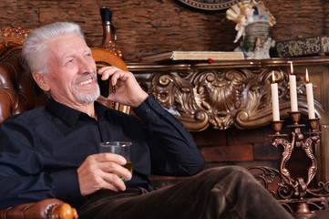 Portrait of smiling senior man talking on phone