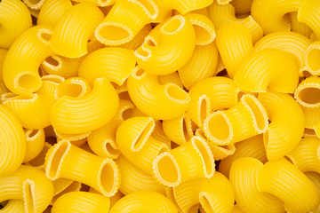 Closeup of lot of whole raw pasta pipe rigate variety flatlay isolated