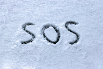 "SOS" written in the snow