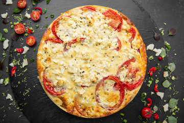Traditional quiche pie with tomatoes, mozzarella and spinach.