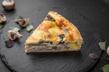 Traditional quiche pie with mushrooms, chicken and cheese.