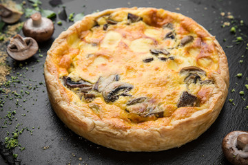 Traditional quiche pie with mushrooms, chicken and cheese.