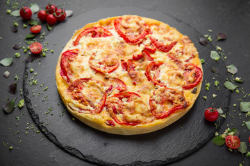 Traditional quiche pie with tomatoes, mozzarella and spinach.