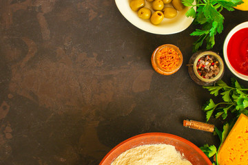 dough ingredients set and filling, sauce (flour, olives, greens and more). food background. copy...