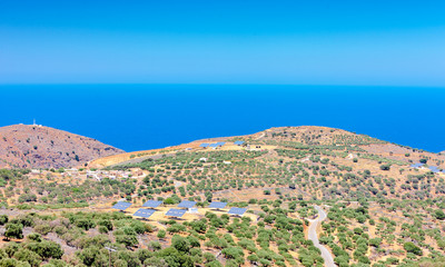 Fototapeta na wymiar Solar panels in olive grove. Crete. Greece