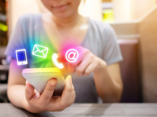 Asian woman hand using smartphone with icon telephone email mobile phone and address. Contact us connection concept