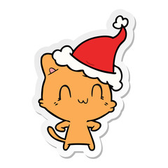 sticker cartoon of a happy cat wearing santa hat