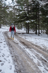 Young teenage girl  walking on a frozen road at Troodos mountains in Cyprus