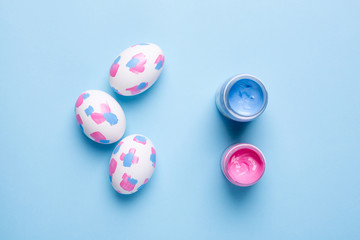 Easter eggs with watercolor brushstrokes on a blue background
