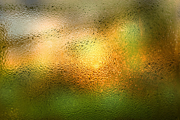 Fototapeta na wymiar bright background with raindrops on window glass
