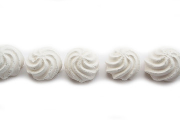 Small white meringues  isolated on white background