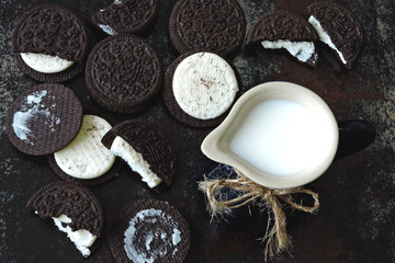 Obraz na płótnie Canvas A jug of milk and chocolate milk cookies.