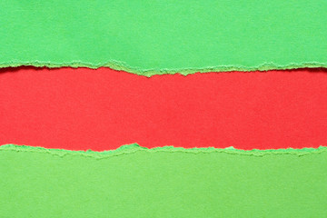 Torn green paper with a red background