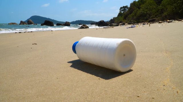 Plastic bottle on sea shore. Ocean Scenery Rubbish And Pollution Slow motion