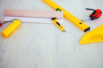 Tools on the floor for sticking wallpaper.