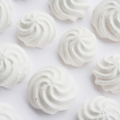 Small white meringues  isolated on white background
