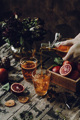Refreshing Orange drink on a dark wooden background