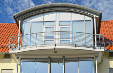 Fototapeta na wymiar Seitengiebel eines modernen Wohnhauses als Rundgaube mit Edelstahlbalkon