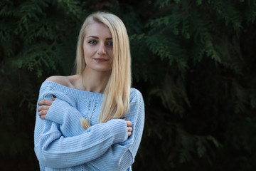 Obraz premium Beautiful young girl, blonde with long hair on the background of green.