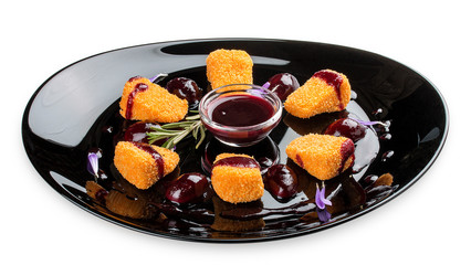 Fried Camembert with cranberry sauce on a glossy black plate