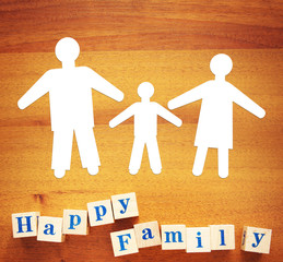 Concept of Happy Friendly Family. Paper cuttings and wooden cubes on a desk