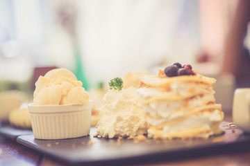 Ice cream with cream on the wooden table. Selective focus.