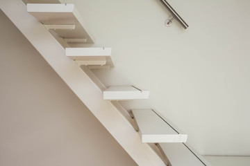 white modern wooden Staircase and white wall close-up