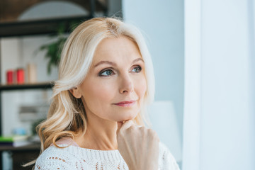 Fototapeta premium pensive woman standing and thinking at home