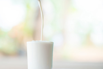 Healthy milk poured into the glass.
