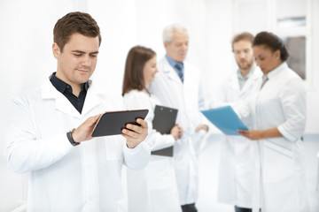 Fototapeta premium Doctor using a digital tablet while working at the hospital